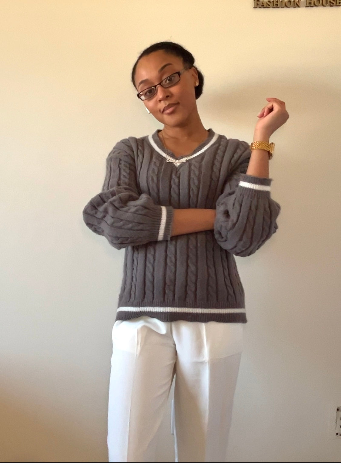 Gray cable-knit sweater with white wide-leg pants