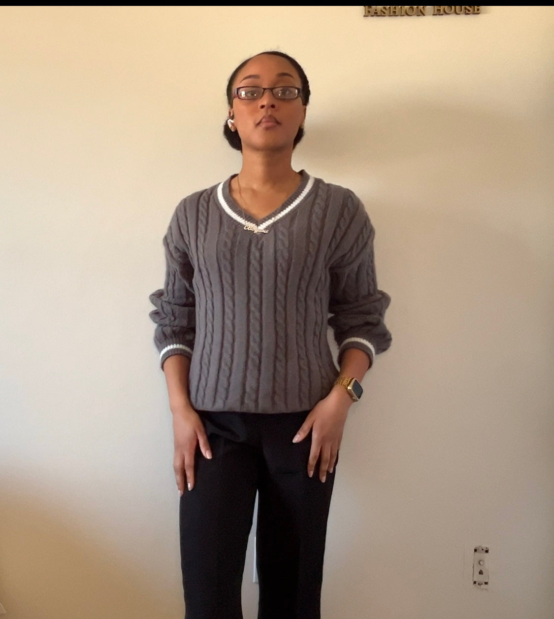 Gray cable-knit sweater with black wide-leg pants