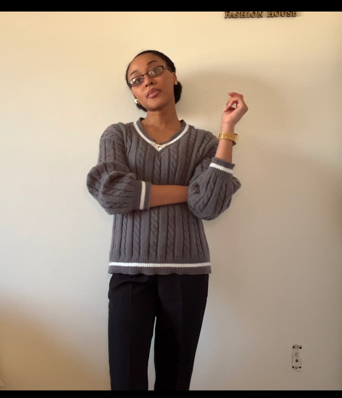 Gray cable-knit sweater with black wide-leg pants