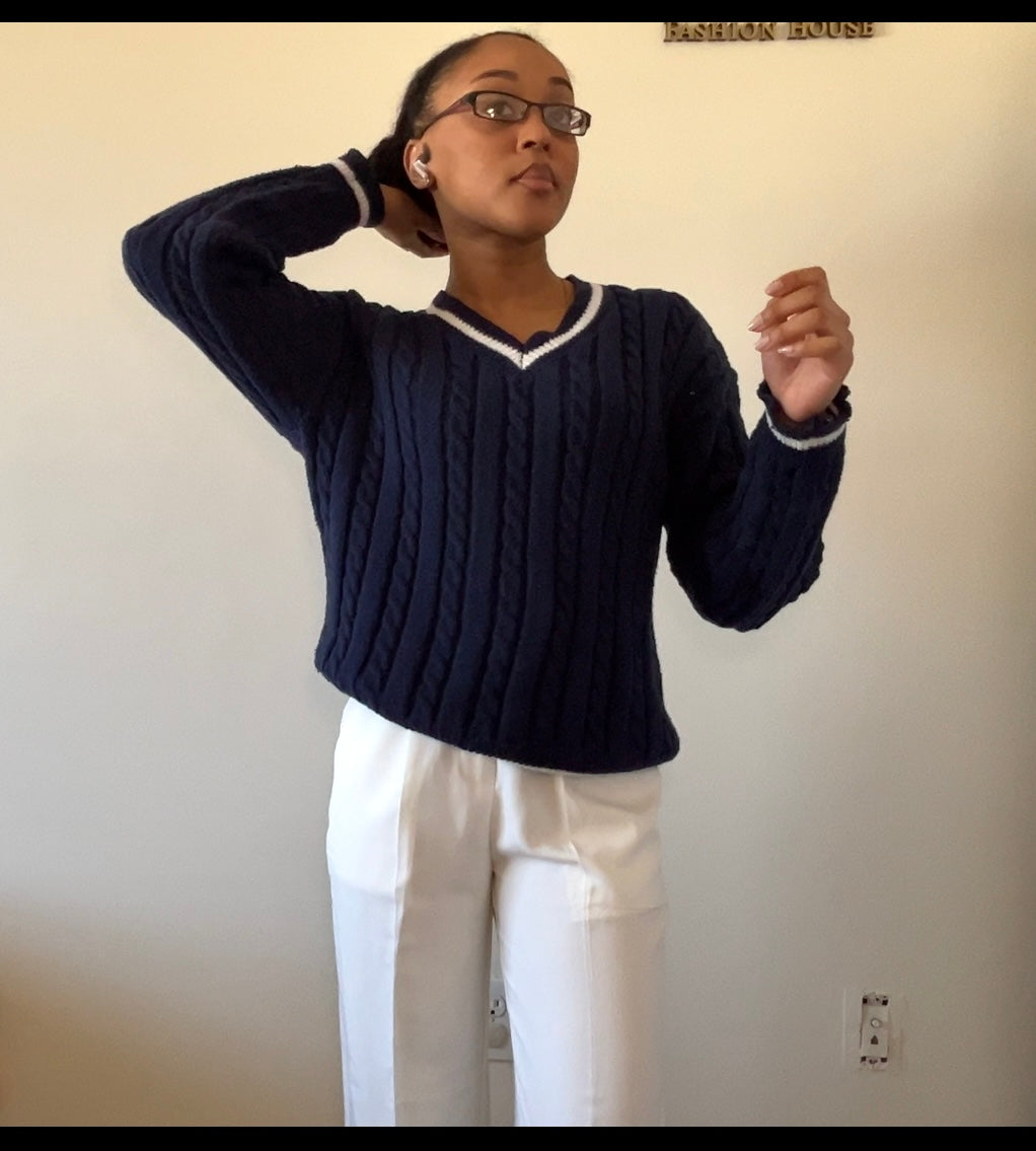 Navy blue cable-knit sweater with white wide-leg pants